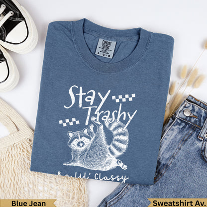Blue Jean Comfort Colors sweatshirt with raccoon and "Stay Trashy Lil' Classy" text.