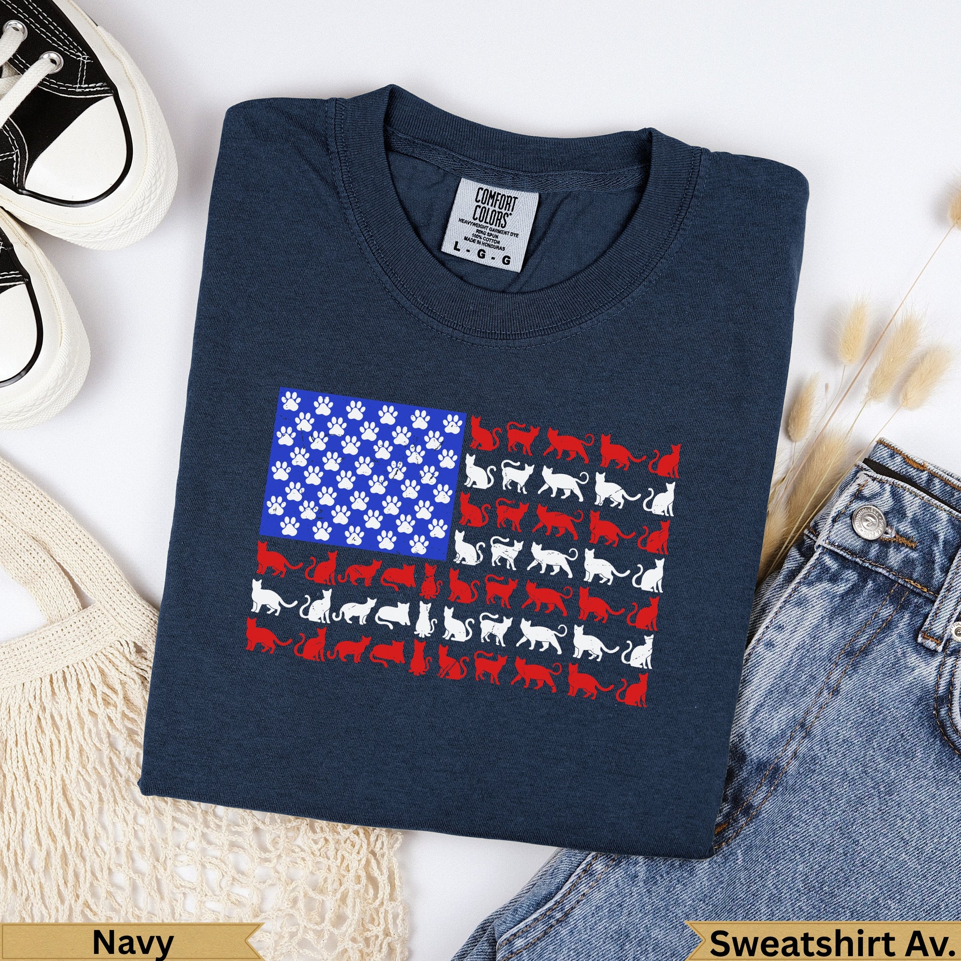 Navy t-shirt with American flag design made of white cat silhouettes and paw prints.