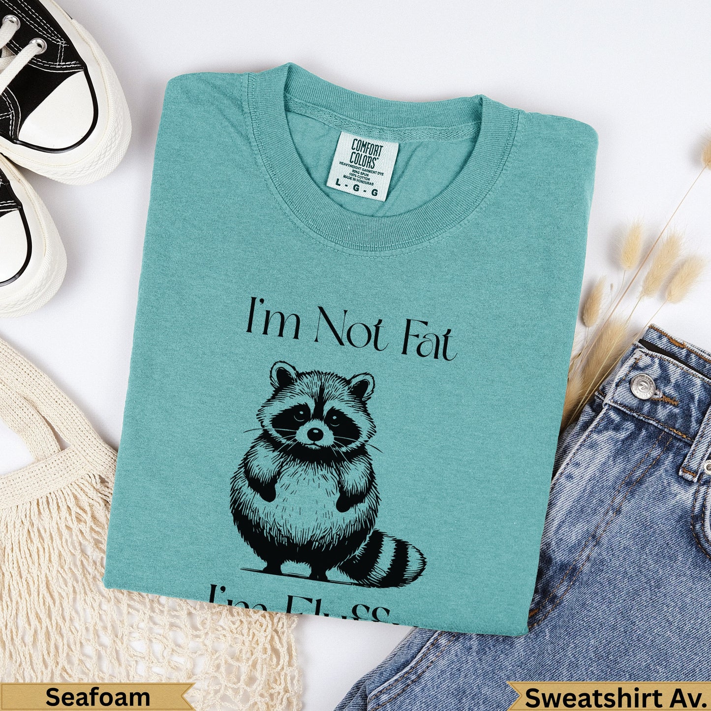 Teal sweatshirt with "I'm Not Fat" and a raccoon graphic.