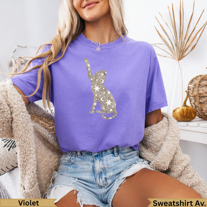 Purple t-shirt with silver cat constellation graphic and moon and star accents.