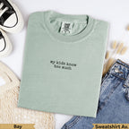 Mint green Comfort Colors sweatshirt with "my kids know too much" text.