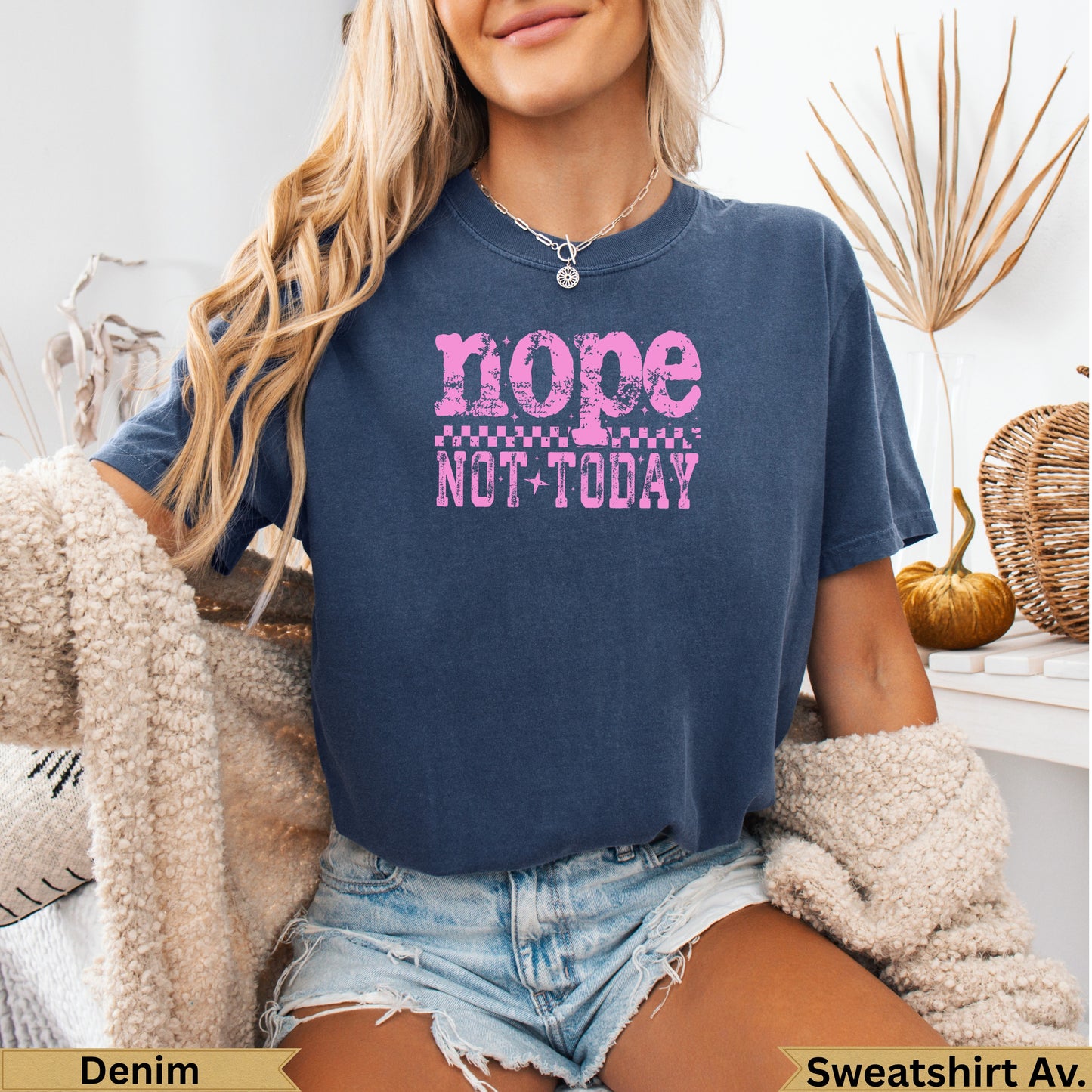 Woman wearing a navy blue t-shirt with "nope not today" graphic.