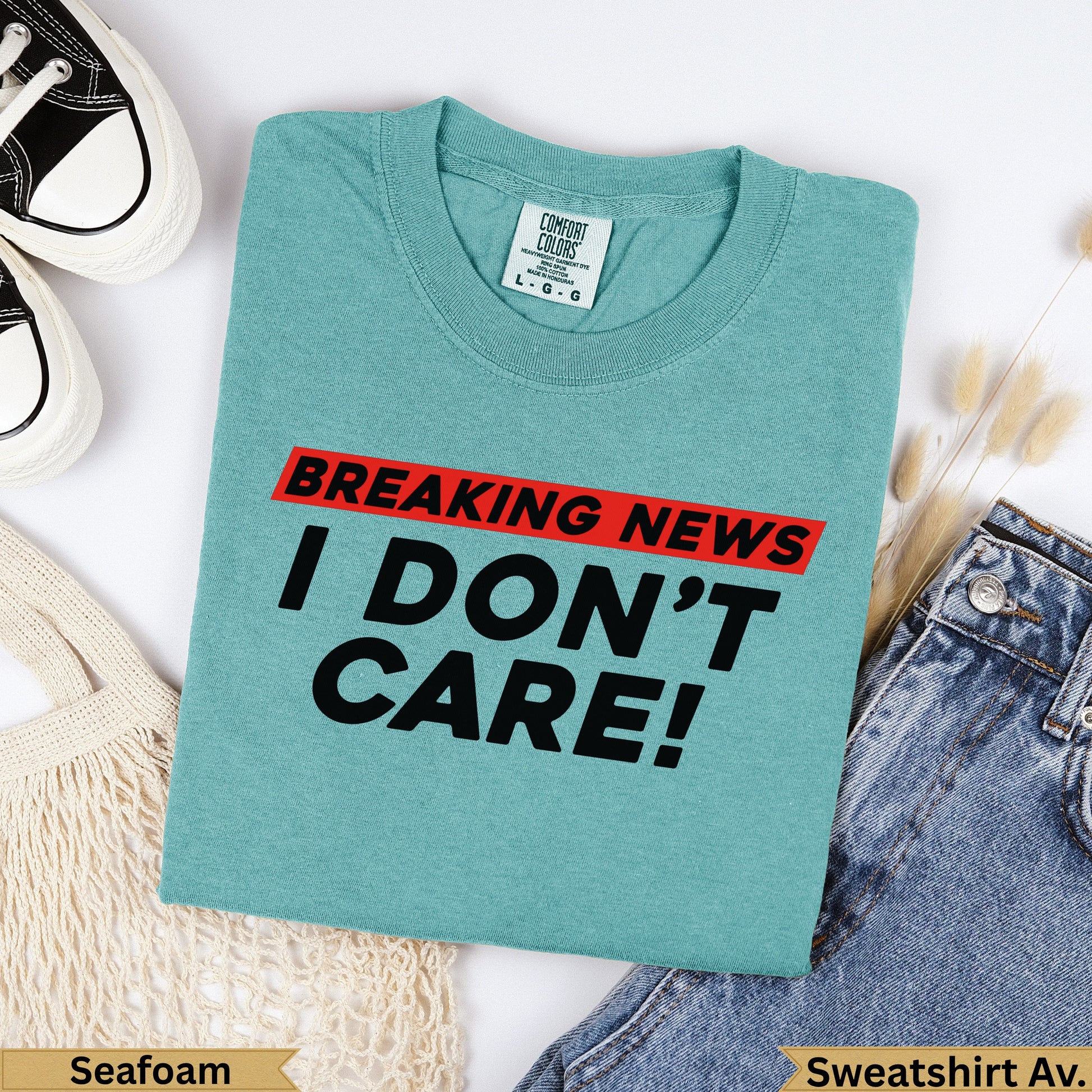 Teal Comfort Colors t-shirt with "BREAKING NEWS I DON'T CARE!" graphic.