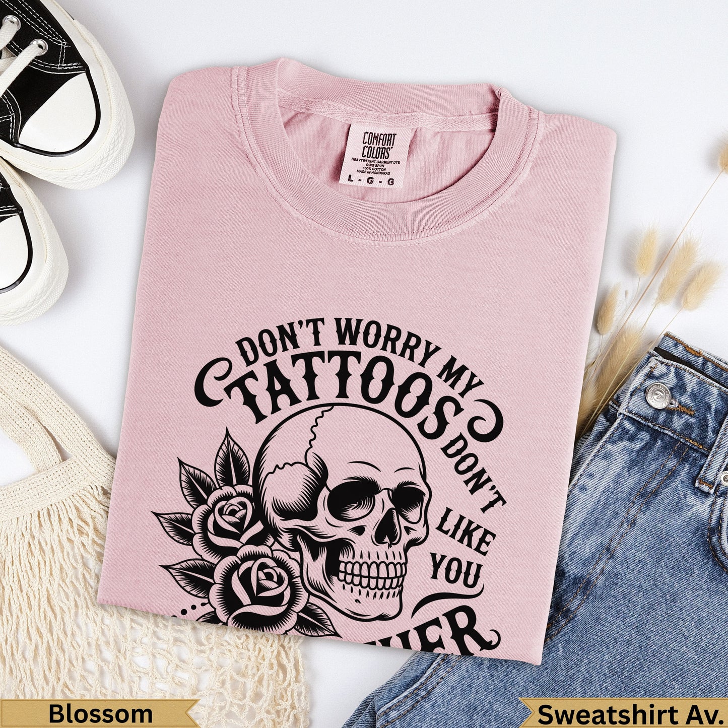 Pink Comfort Colors sweatshirt with skull, roses, and text "Don't worry my tattoos don't like you".