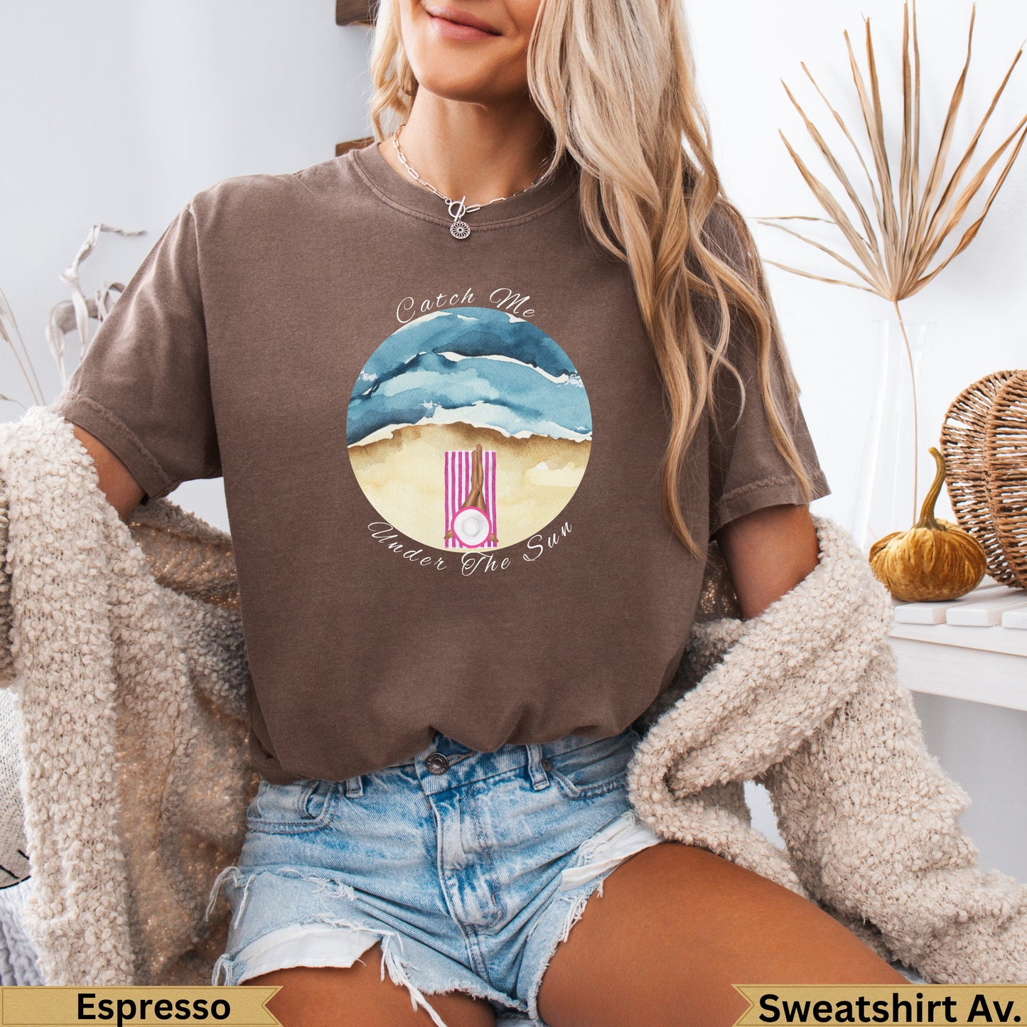 Brown t-shirt with watercolor beach scene and "Catch Me Under The Sun" text.