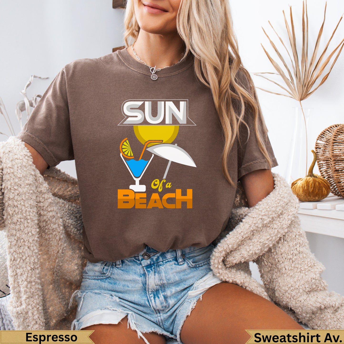 Brown t-shirt with "Sun of a Beach" text and tropical drink graphic.