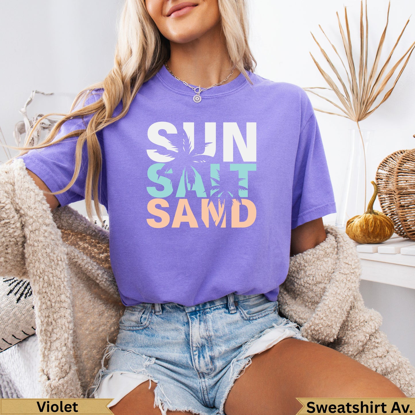 Purple t-shirt with SUN, SALT, SAND text design.