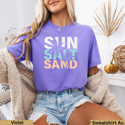 Purple t-shirt with SUN, SALT, SAND text design.