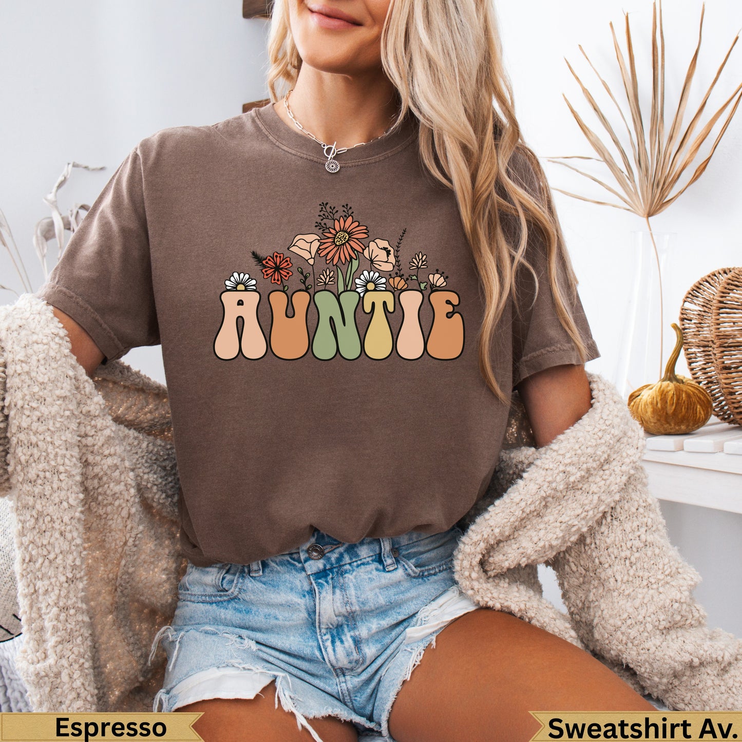 Brown t-shirt with "Auntie" in colorful floral lettering.