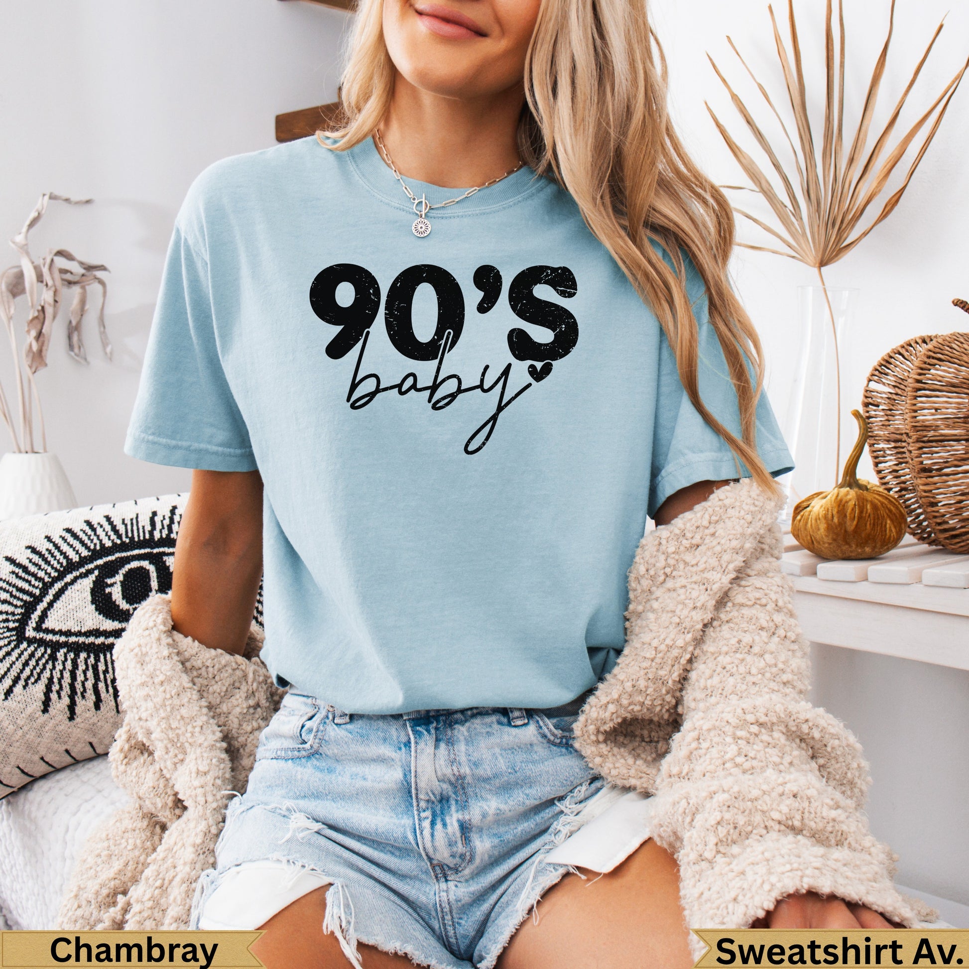 Light blue t-shirt with "90's baby" in black text.