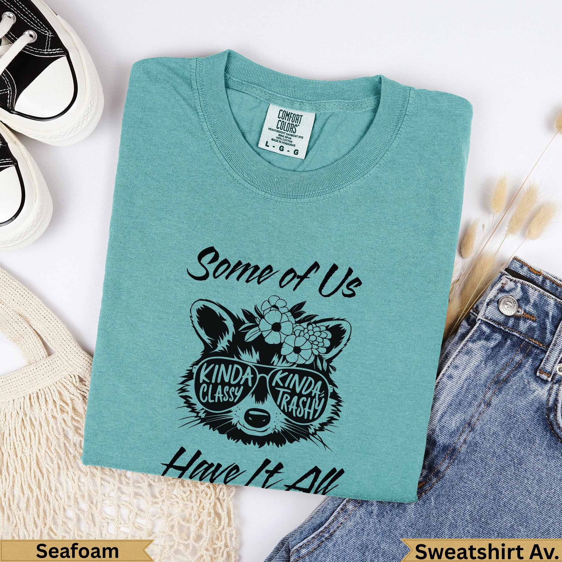 Teal sweatshirt with "Some of Us Kinda Classy Kinda Trashy Have It All" and raccoon graphic.