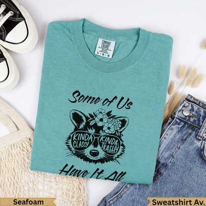 Teal sweatshirt with "Some of Us Kinda Classy Kinda Trashy Have It All" and raccoon graphic.