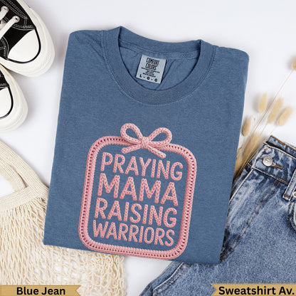Blue Jean Comfort Colors t-shirt with "PRAYING MAMA RAISING WARRIORS" text.