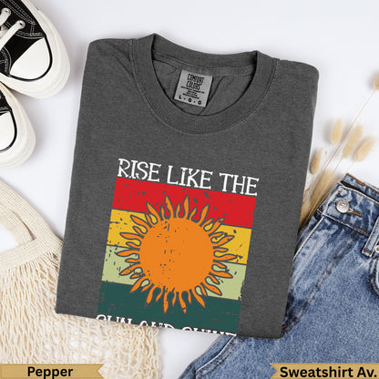 Dark gray Comfort Colors sweatshirt with "Rise Like the Sun" graphic.