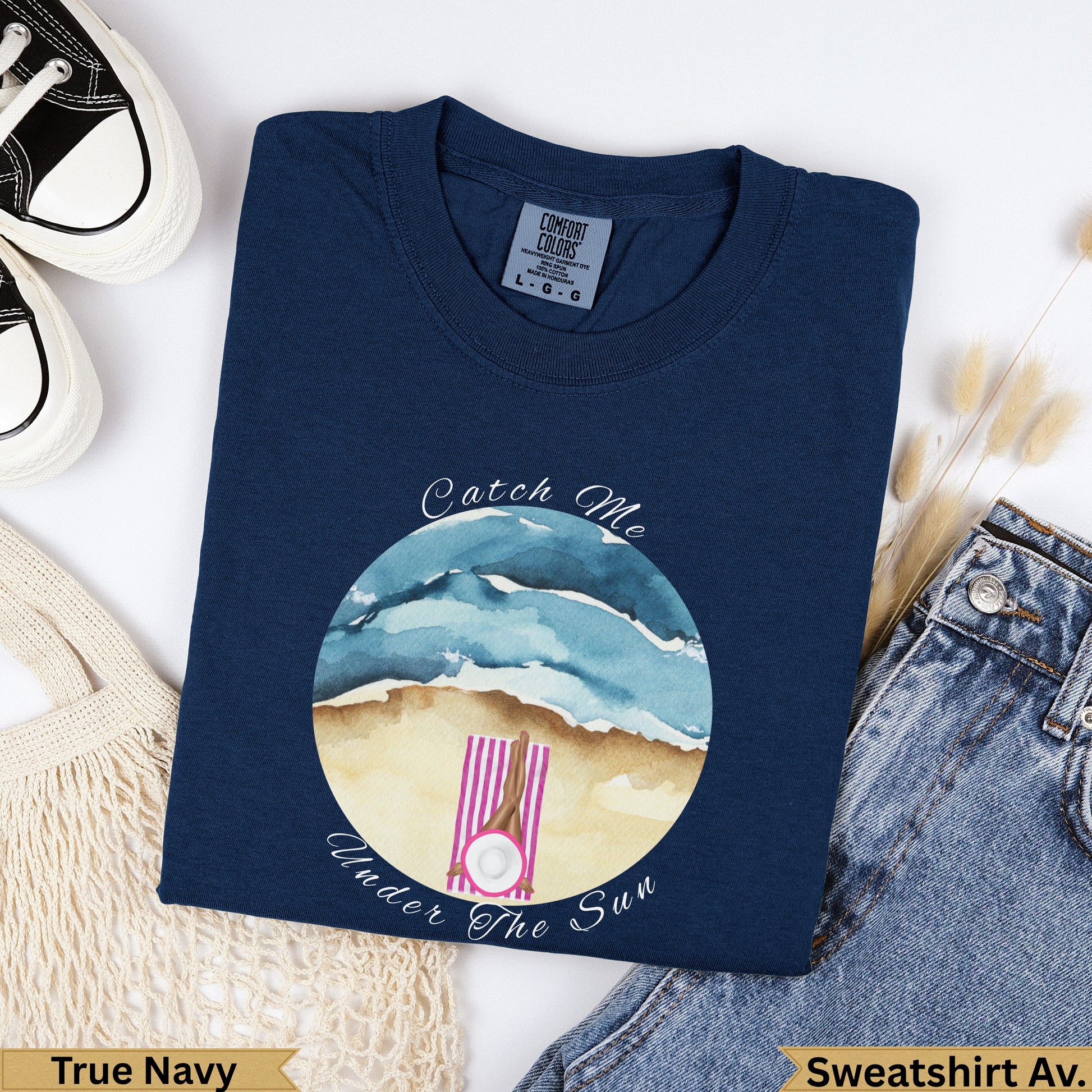Navy blue graphic t-shirt with "Catch Me Under The Sun" beach graphic.