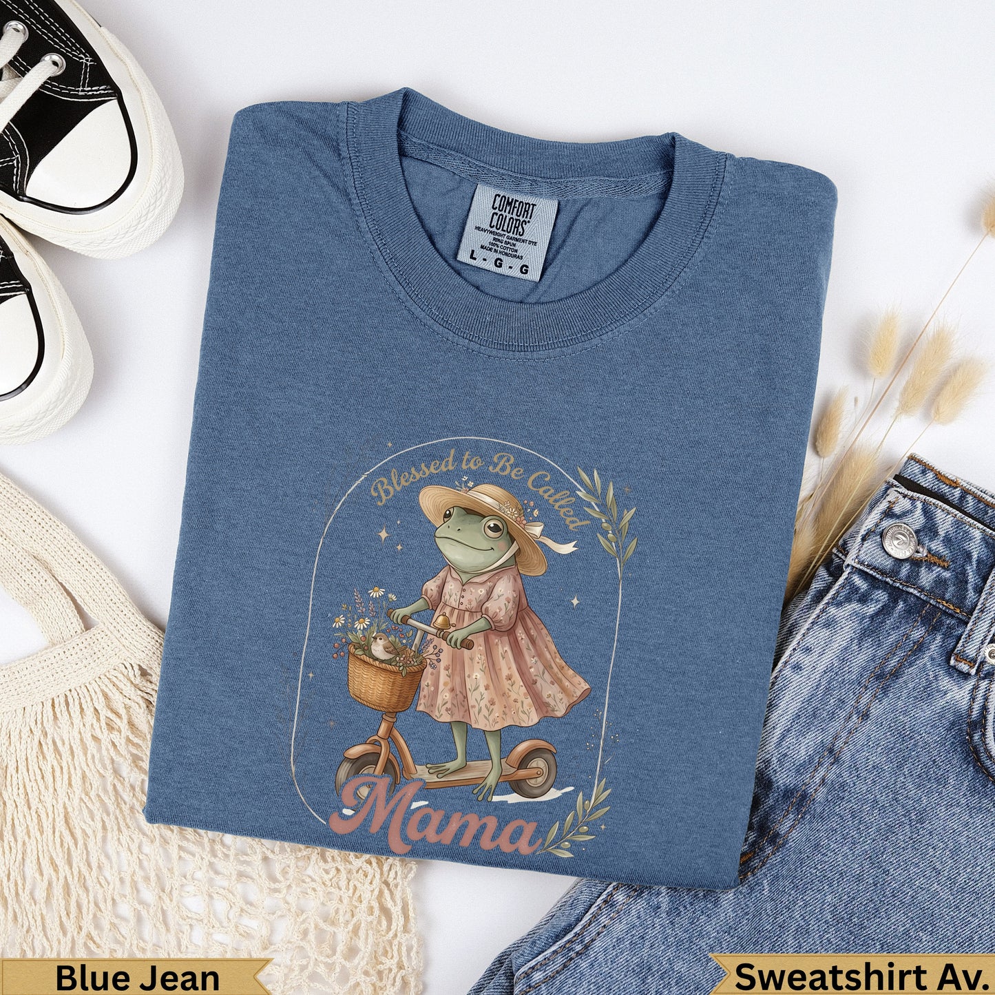 Frog in dress and hat rides scooter with flowers, text "Mama".