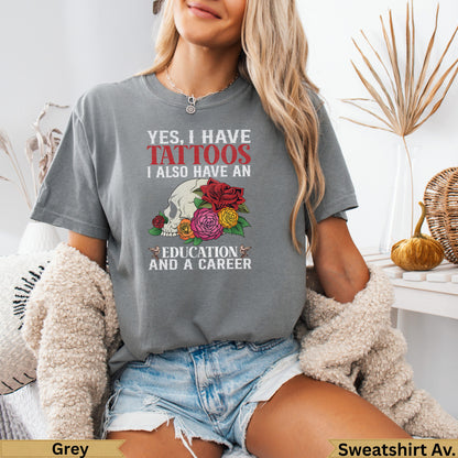 Grey t-shirt with "Yes, I have tattoos. I also have an education and a career" and floral design.