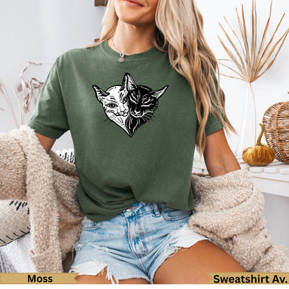 Green t-shirt with split black and white cat face graphic on chest.