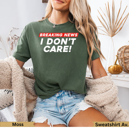 Green t-shirt with "BREAKING NEWS I DON'T CARE!" text.