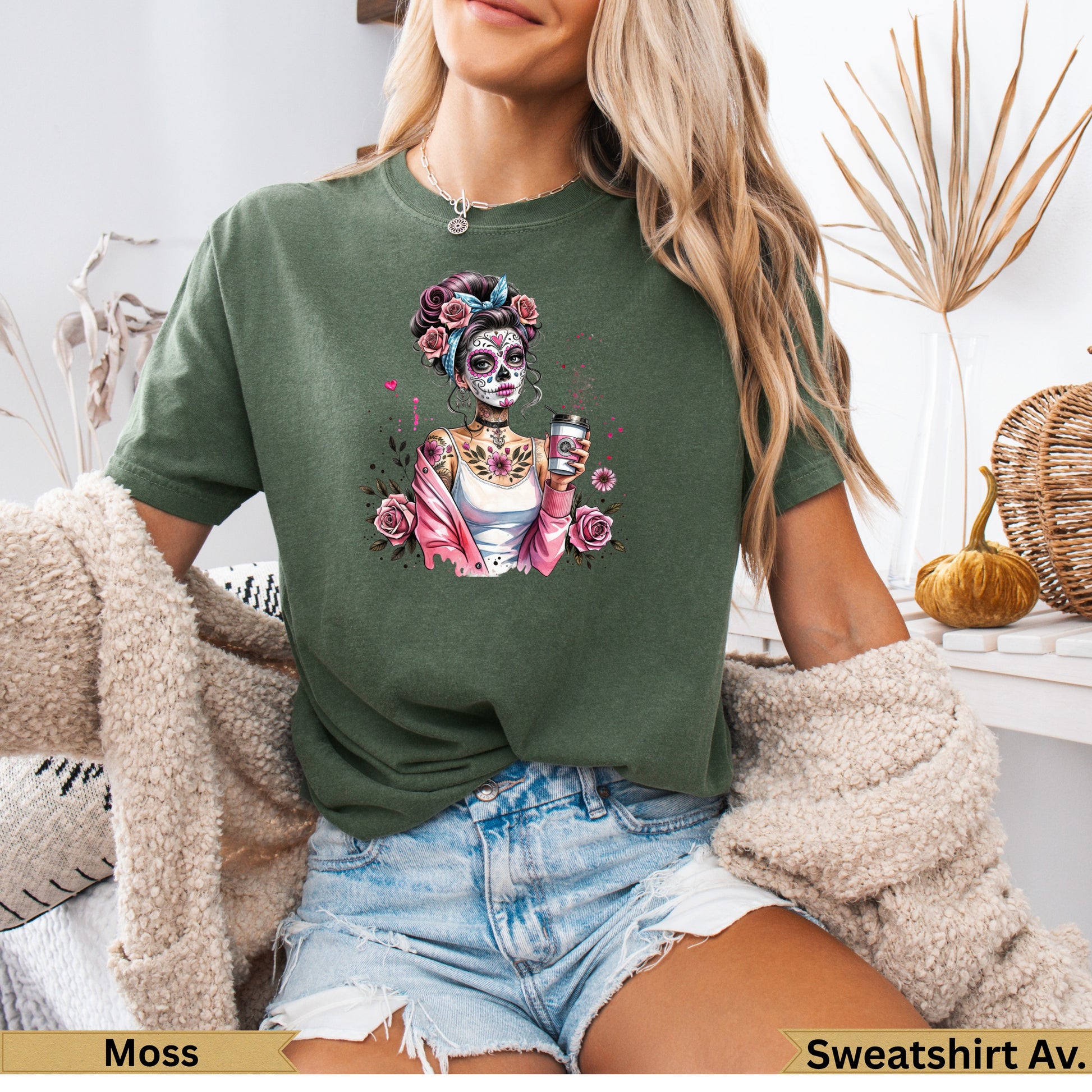 Woman wearing a green graphic t-shirt with a Day of the Dead inspired skeleton design.