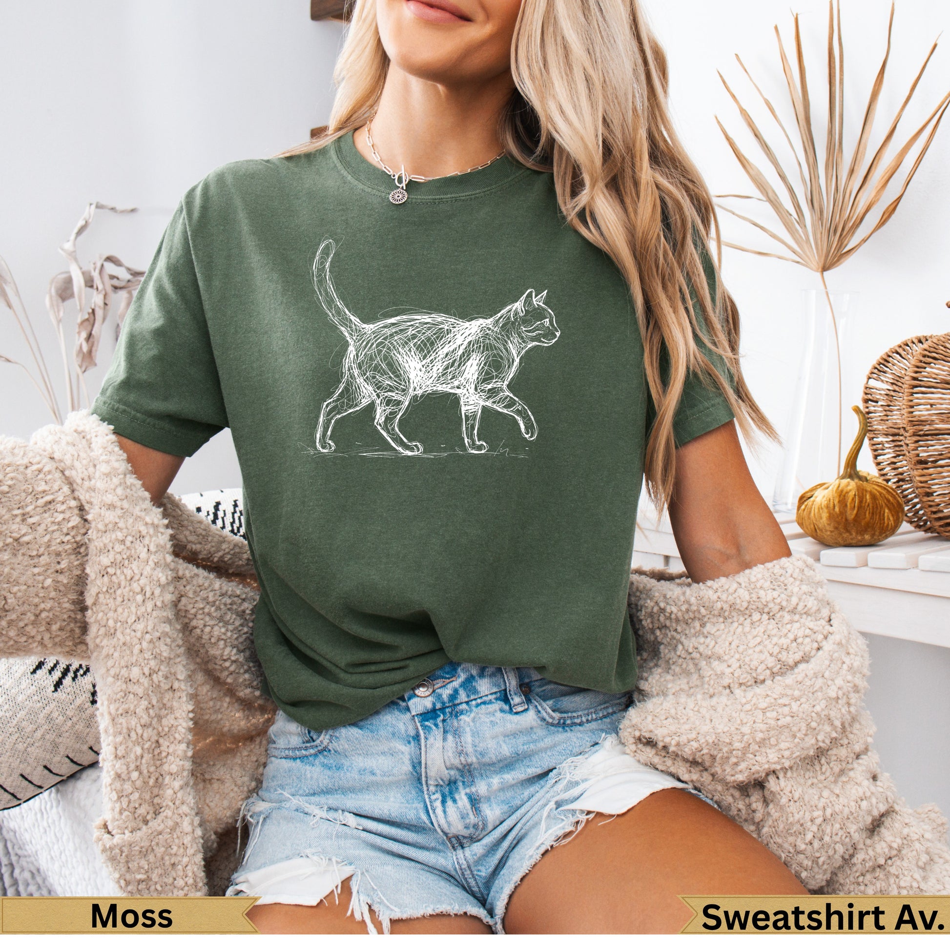 Green t-shirt with a white sketched cat walking across the front.