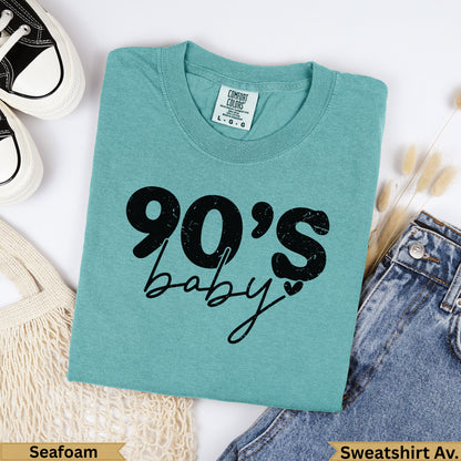 Teal "90's baby" graphic sweatshirt with denim and canvas bag.