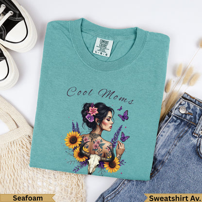Teal Comfort Colors t-shirt with "Cool Moms" text and floral skull design.