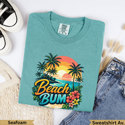 Teal t-shirt with "Beach Bum" text and tropical sunset scene.