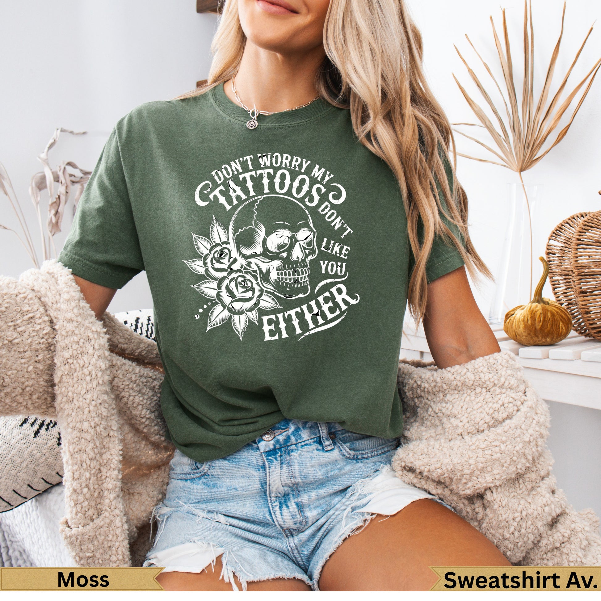Green t-shirt with skull, roses, and "Don't worry my tattoos don't like you either" text.