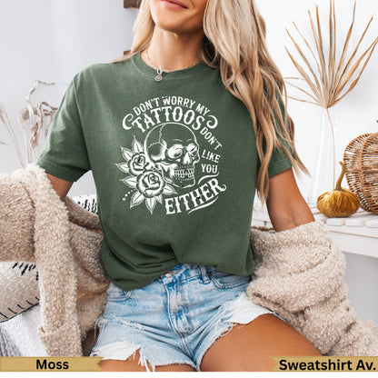 Green t-shirt with skull, roses, and "Don't worry my tattoos don't like you either" text.