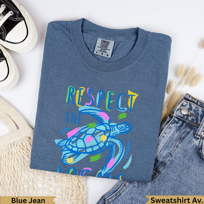 Blue Jean Comfort Colors t-shirt with colorful sea turtle and text "RESPECT THE OCEAN".