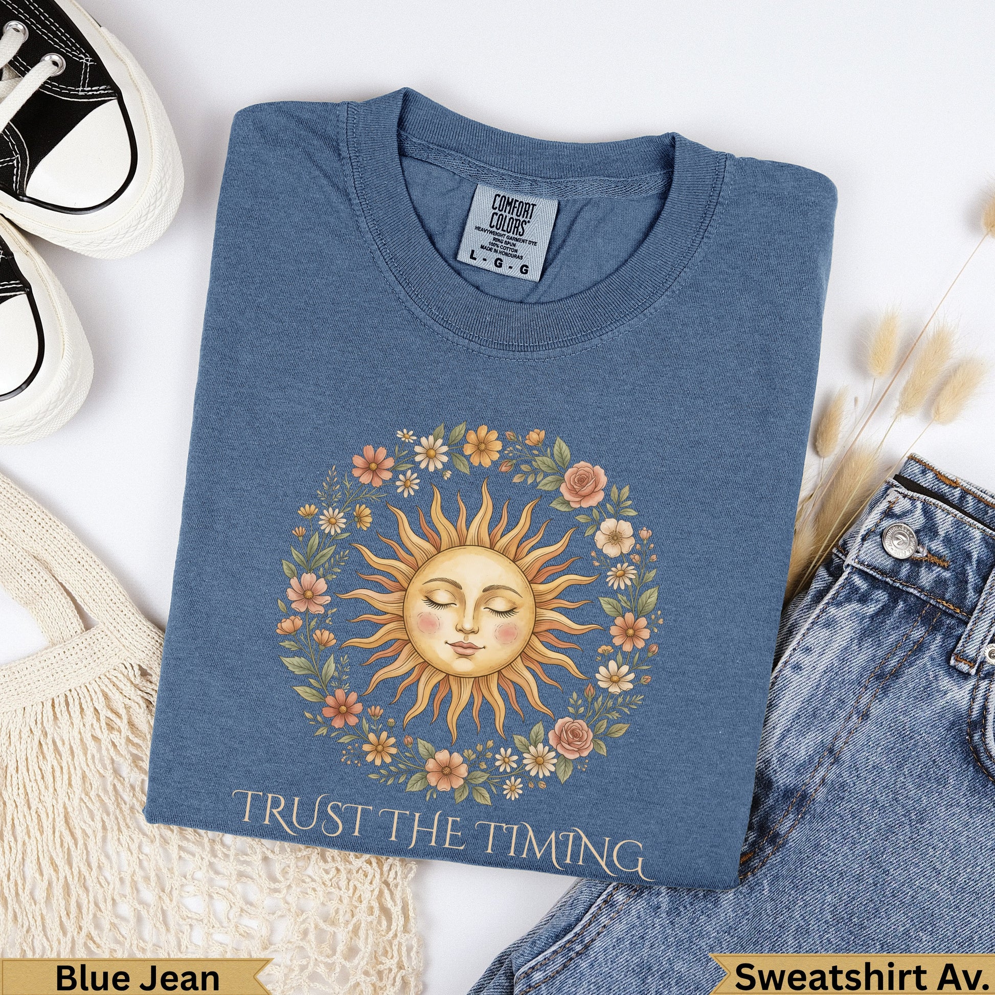 Blue Jean sweatshirt with sun and floral wreath graphic, "Trust the Timing".