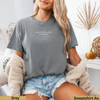 Grey sweatshirt with "apparently, I am dramatic" text, worn by a model.