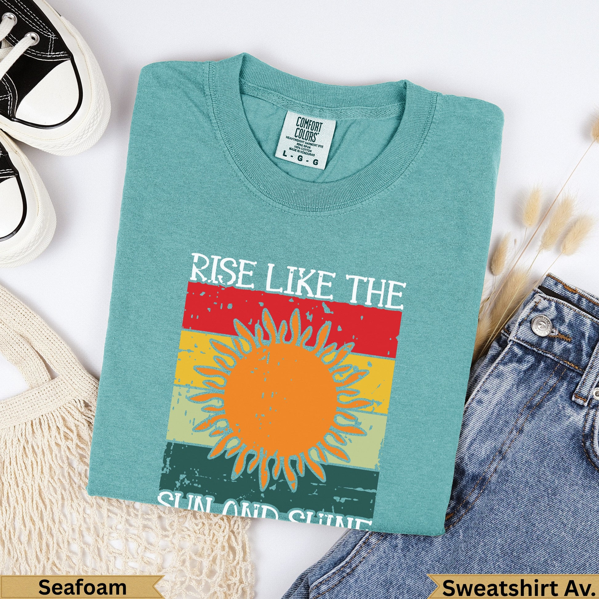 Seafoam green sweatshirt with "RISE LIKE THE SUN AND SHINE" text.