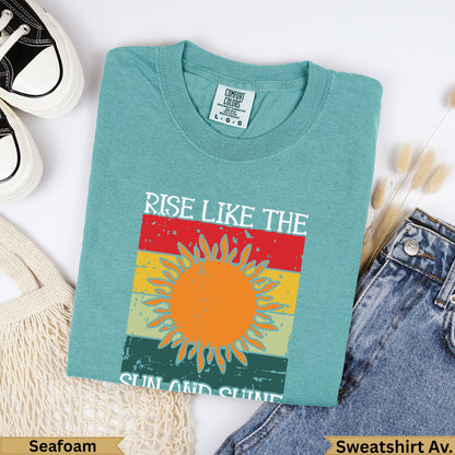 Seafoam green sweatshirt with "RISE LIKE THE SUN AND SHINE" text.
