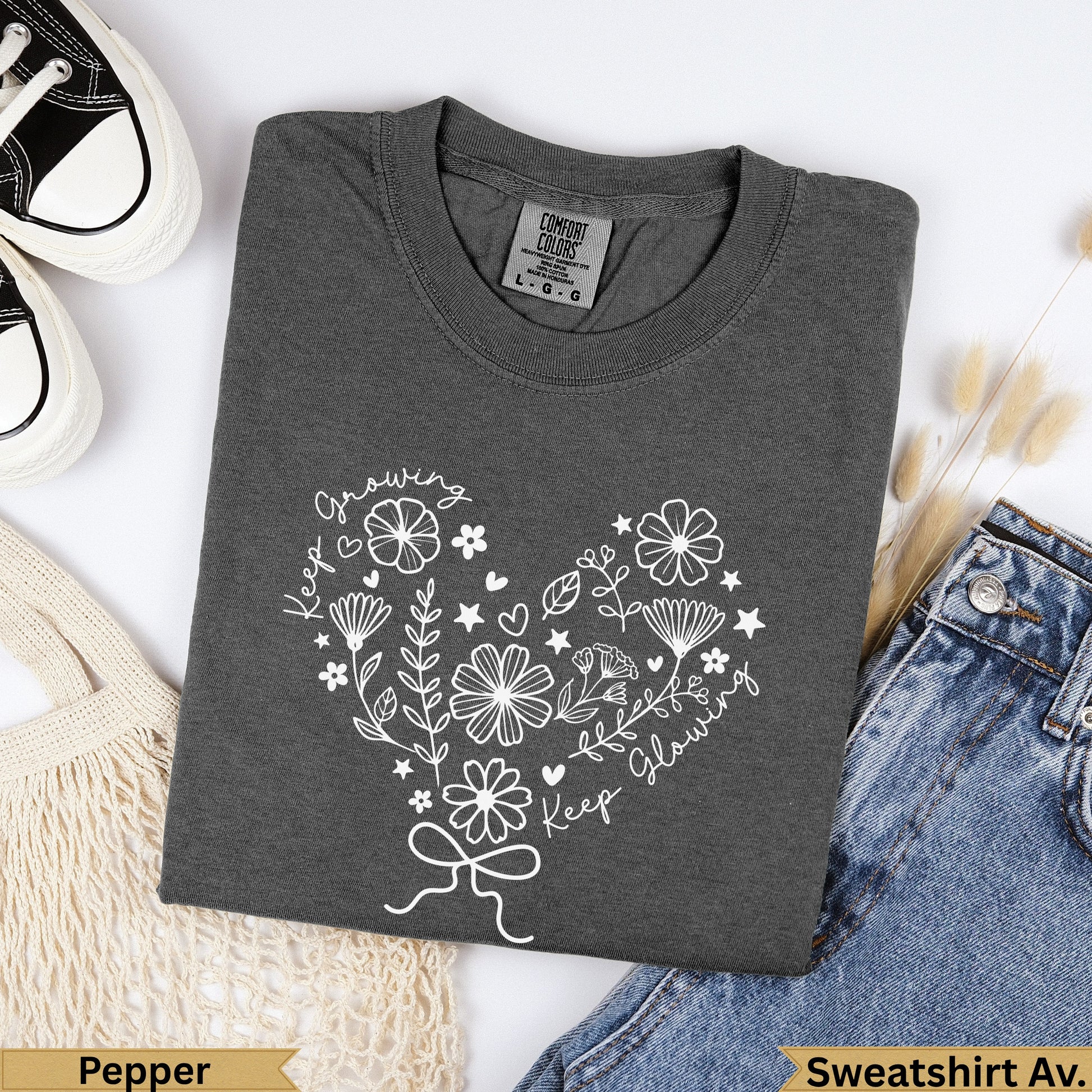 Dark grey t-shirt with "Keep Growing Keep Glowing" heart floral design.