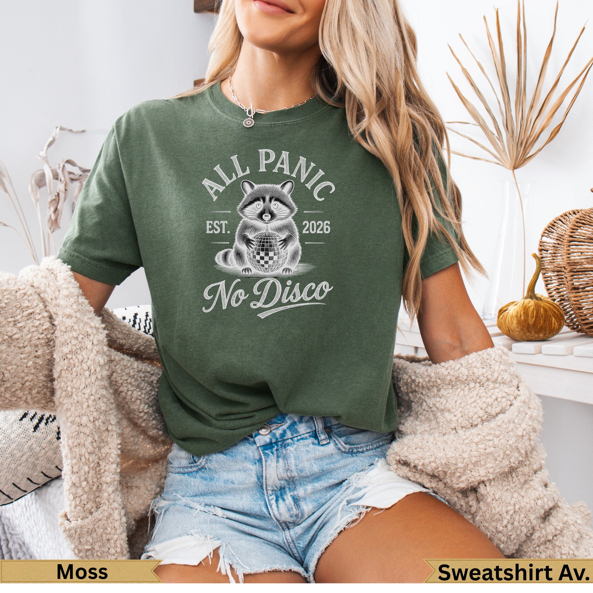 Green t-shirt with raccoon, disco ball, and "All Panic No Disco" text.