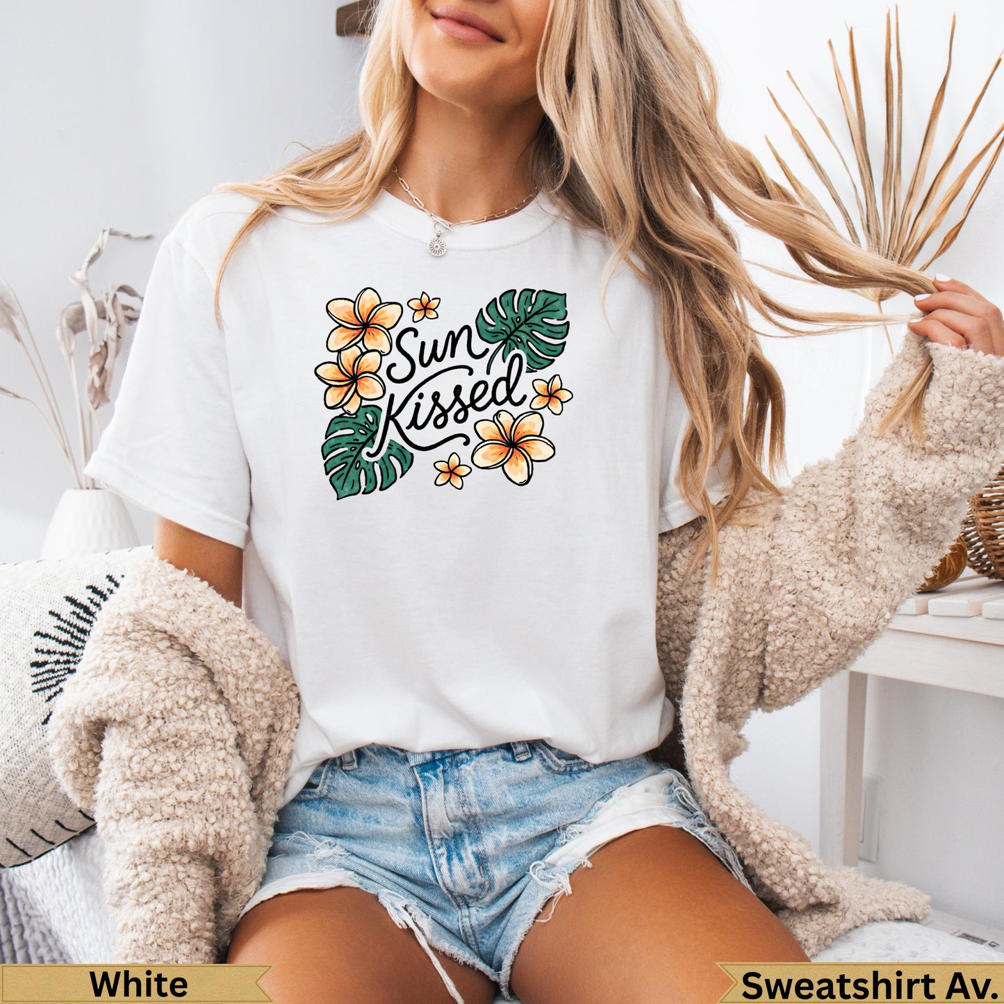 White t-shirt with "Sun Kissed" text and floral and leaf graphic.
