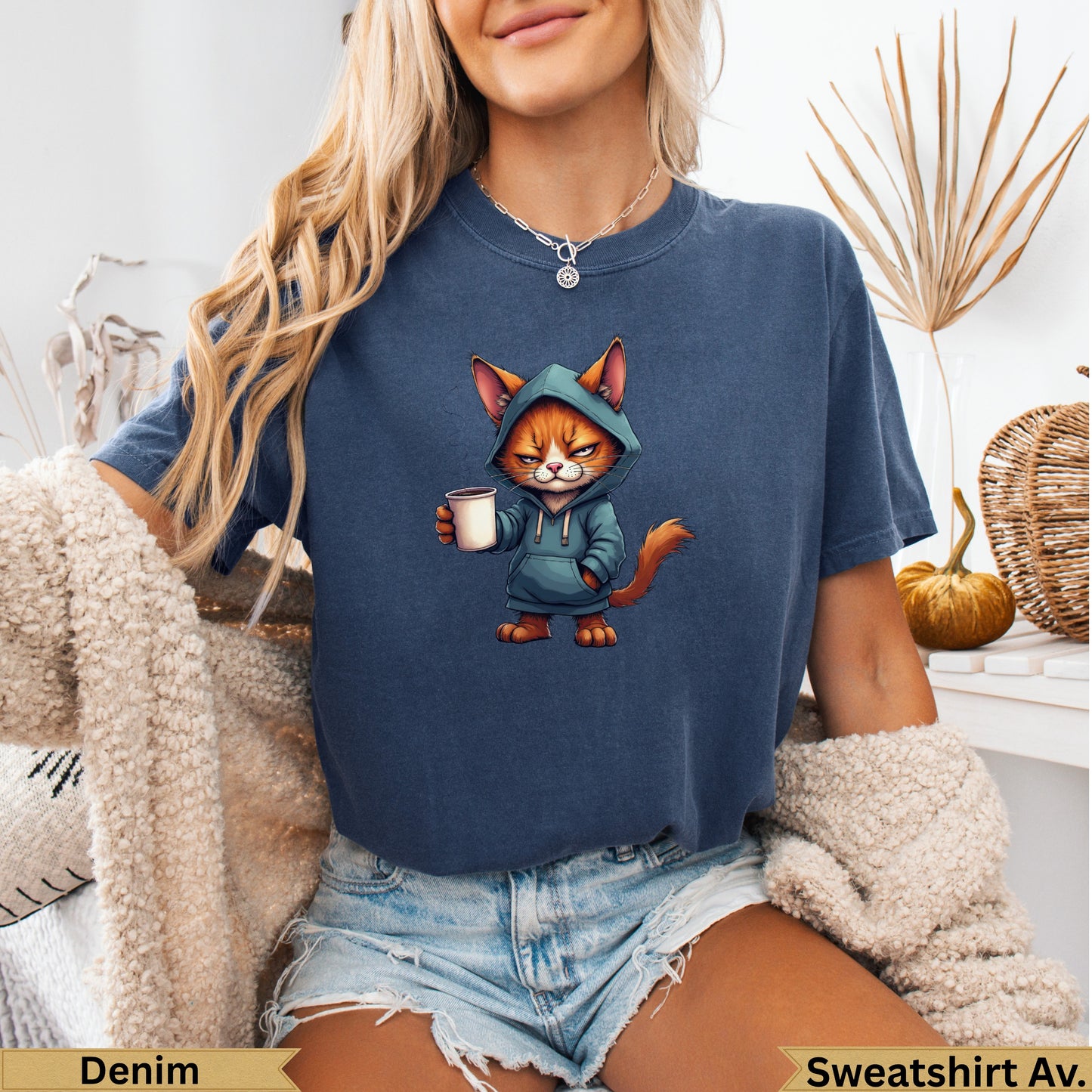 Blue sweatshirt featuring a cartoon cat wearing a hoodie and holding a coffee cup.