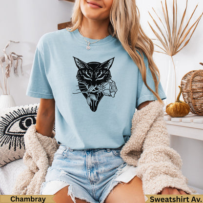 Black wolf head with rose in mouth on light blue t-shirt.