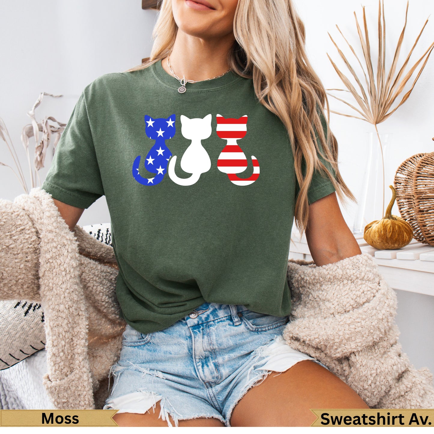 Three cats wearing patriotic American flag patterns sit together on a t-shirt.