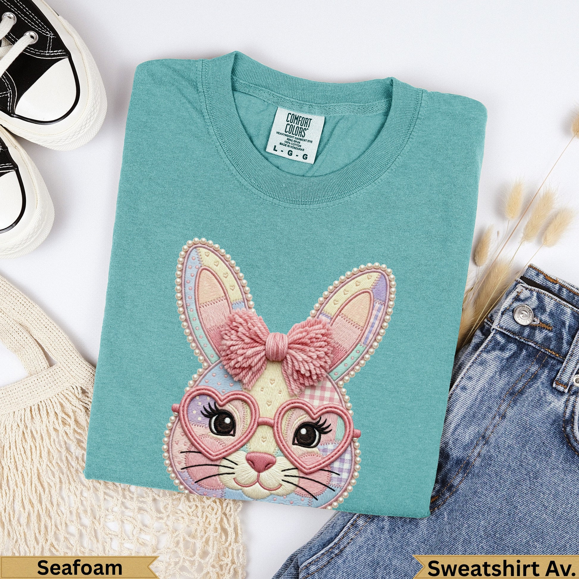Seafoam green cotton sweatshirt with embroidered bunny wearing heart glasses.