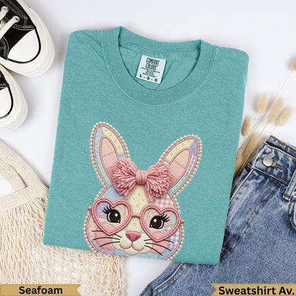 Seafoam green cotton sweatshirt with embroidered bunny wearing heart glasses.