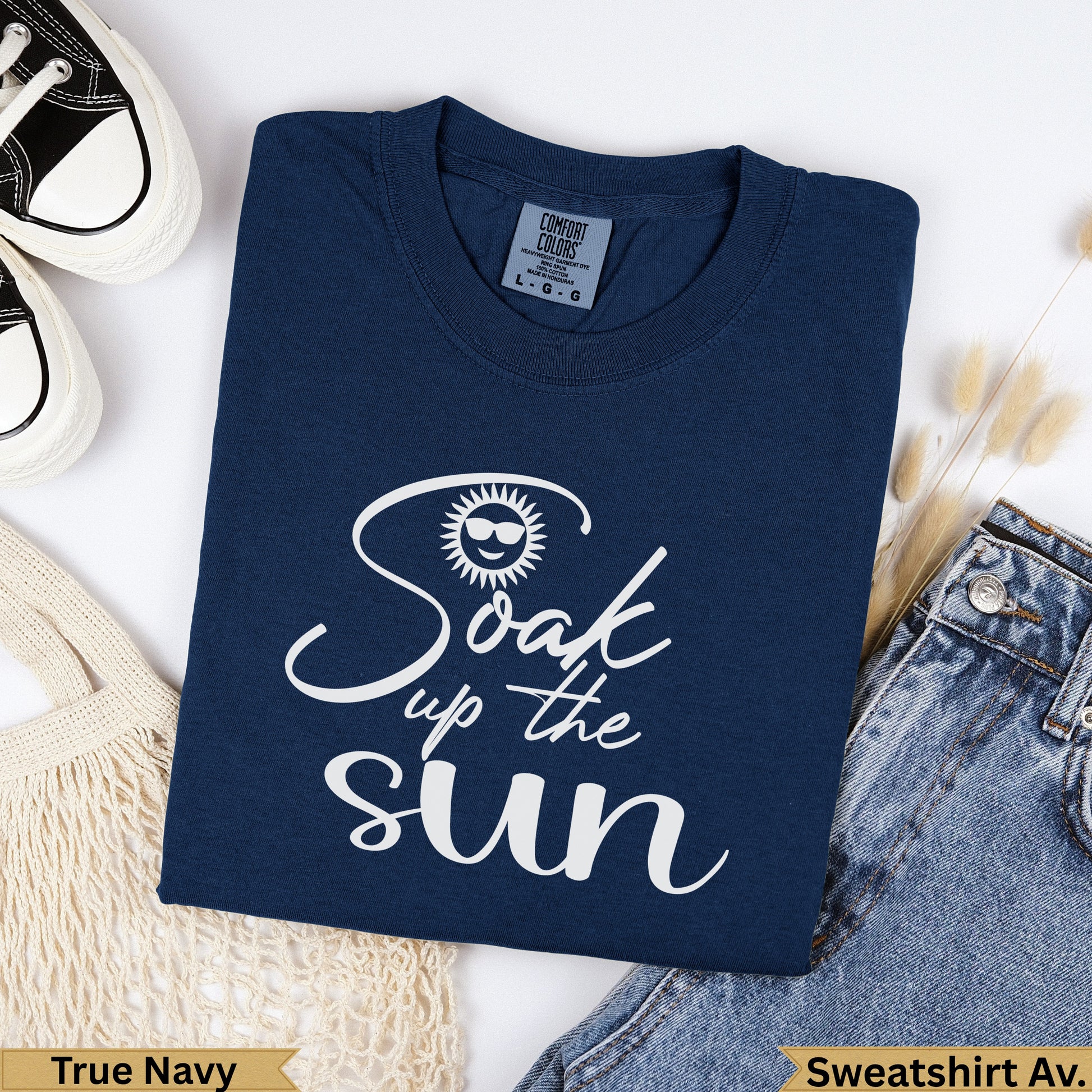 Navy blue sweatshirt with "Soak up the sun" text and sunglasses graphic.