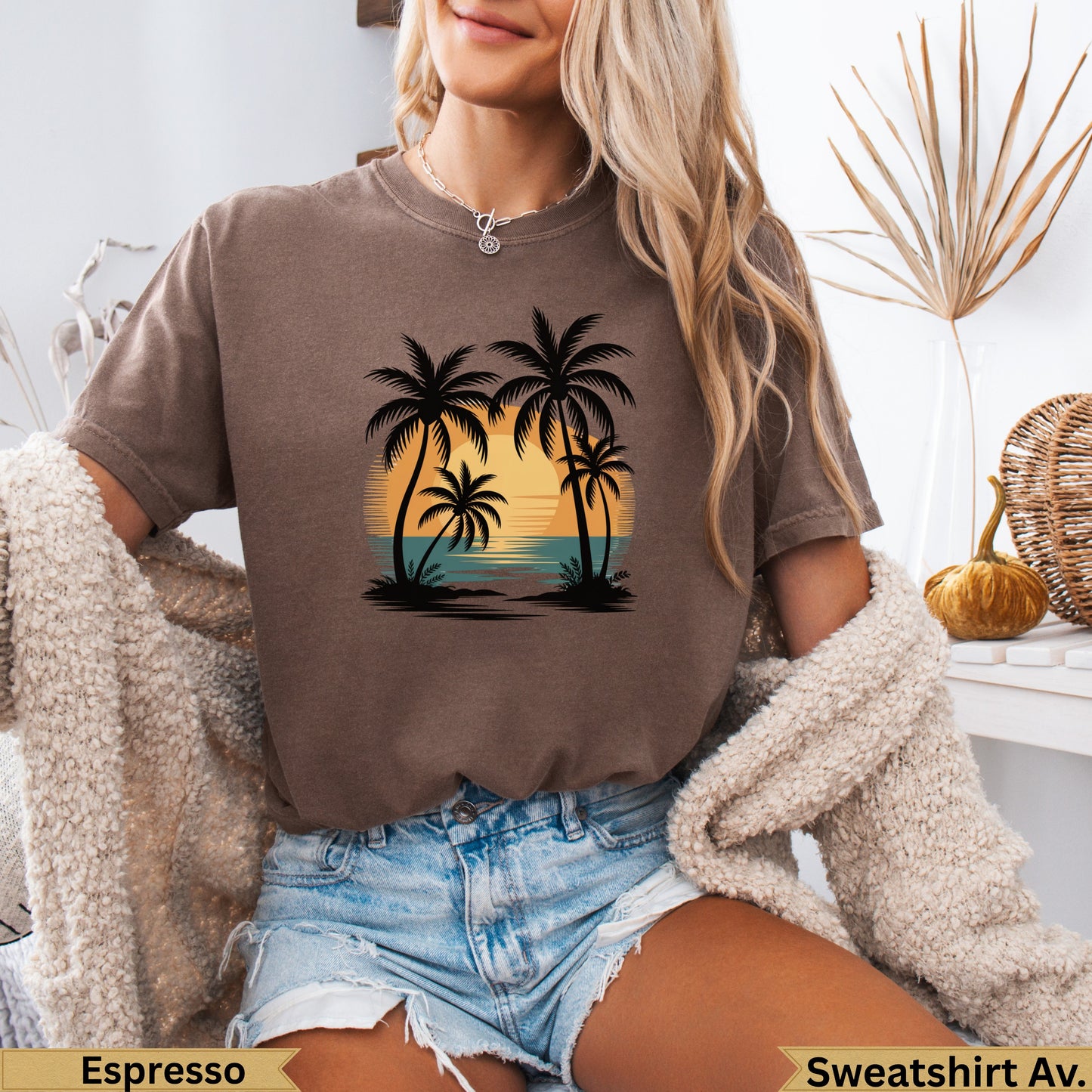 Brown t-shirt with a sunset beach scene and palm trees graphic.