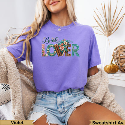 Purple t-shirt with "Book Lover" text adorned with floral accents.