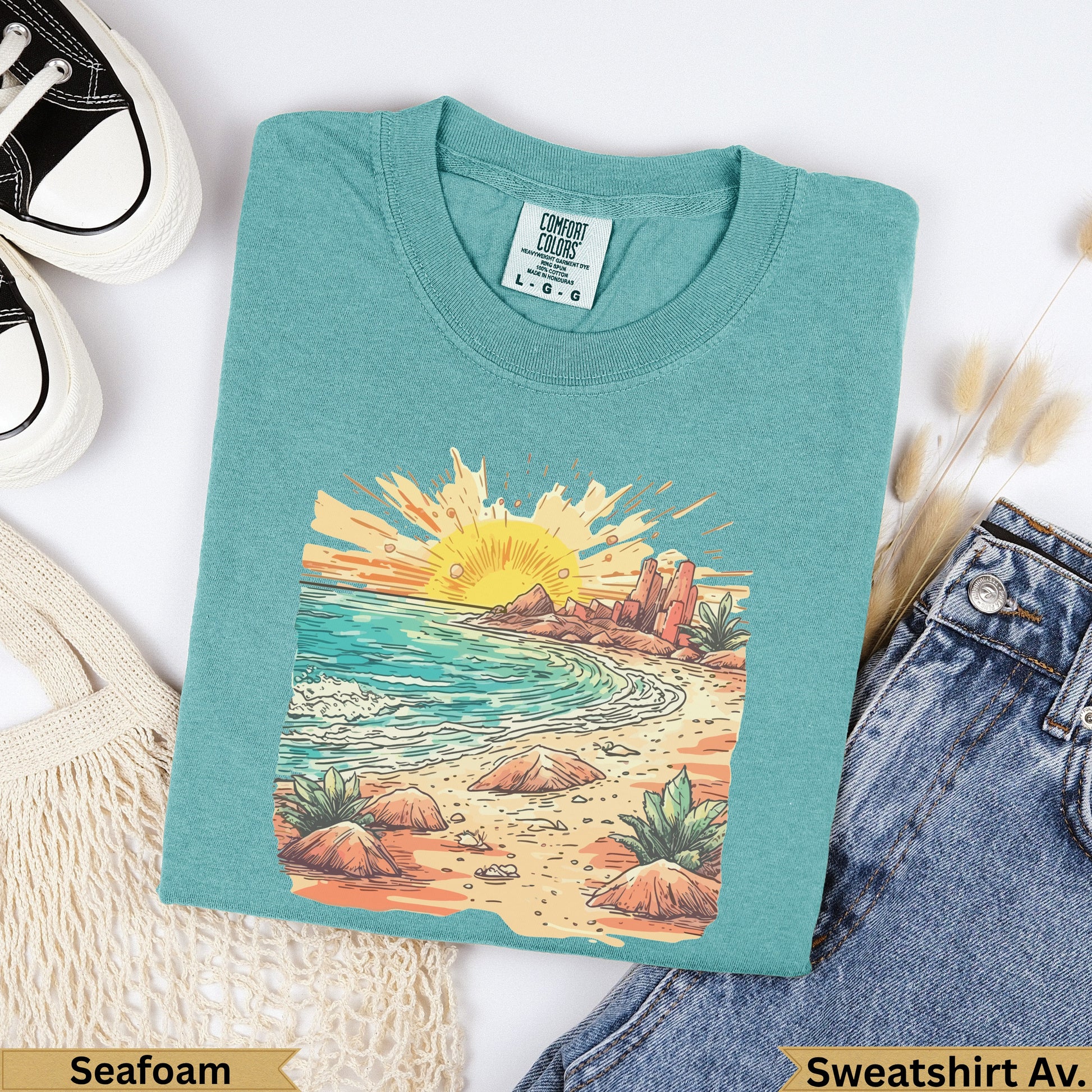 Teal t-shirt with sunset beach graphic and "Seafoam" text.