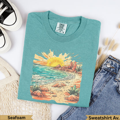 Teal t-shirt with sunset beach graphic and "Seafoam" text.