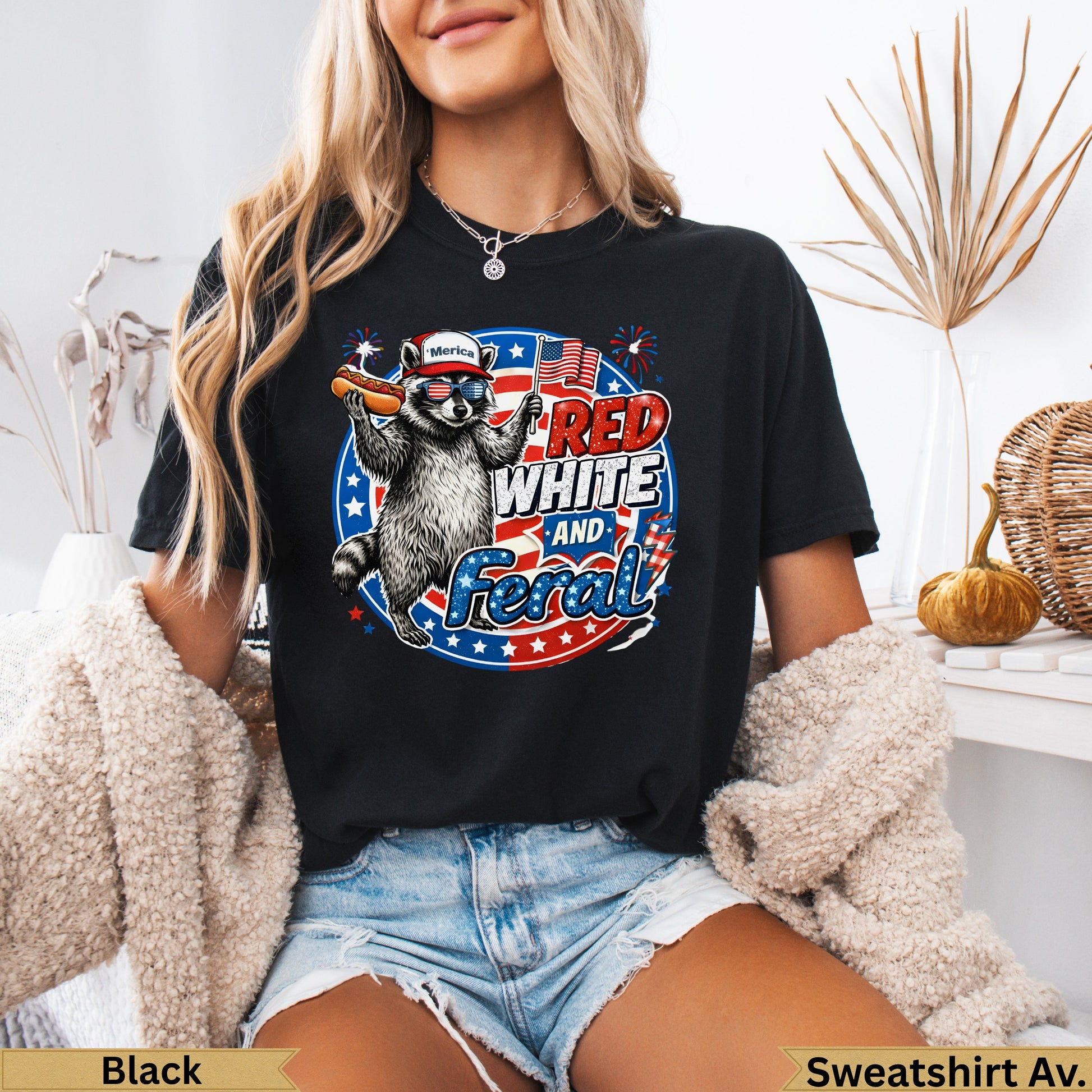 Raccoon in sunglasses wearing a bandana, holding a hot dog, with "America RED WHITE and FERAL" text.