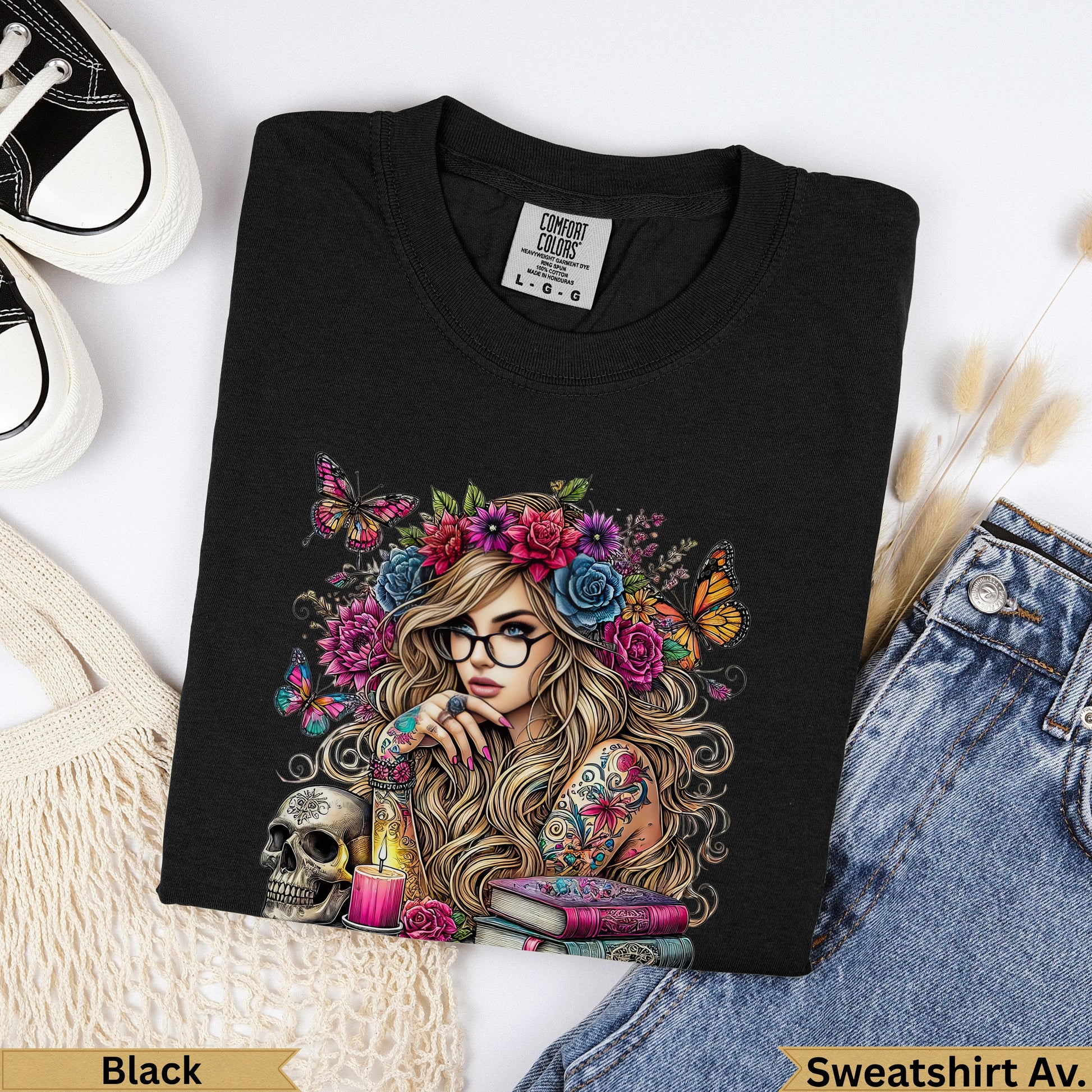 Black Comfort Colors sweatshirt with floral skull and tattooed woman design.